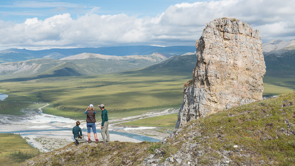 Hikers look over the Firth River, one of the best multi-day rafting trips in Canada.