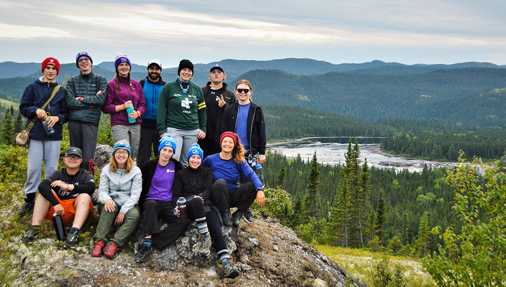 Bishop's College School group photo. Group hiked to a peak with Muteshekau Shipu (Magpie River) in the background.